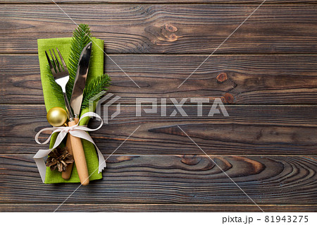 Christmas table place setting with knife, napkin and fork. Holidays new year background with copy space Christmas table place setting with knife, napkin and fork. Holidays new year background with copy space 81943275