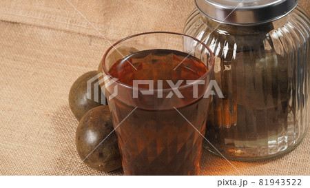 Monk fruit or Luo Han Guo. Dried fruits for healthy sweetener drink. Natural herbal remedy and glass bottle background. Monk fruit drink for who concern health and sugar substitute. Monk fruit or Luo Han Guo. Dried fruits for healthy sweetener drink. Natural herbal remedy and glass bottle background. Monk fruit drink for who concern health and sugar substitute. 81943522
