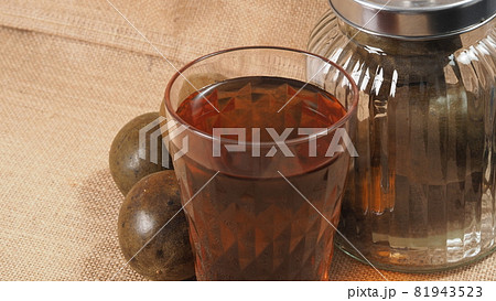 Monk fruit or Luo Han Guo. Dried fruits for healthy sweetener drink. Natural herbal remedy and glass bottle background. Monk fruit drink for who concern health and sugar substitute. 81943523