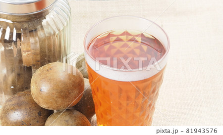 Monk fruit or Luo Han Guo. Dried fruits for healthy sweetener drink. Natural herbal remedy and glass bottle background. Monk fruit drink for who concern health and sugar substitute. 81943576