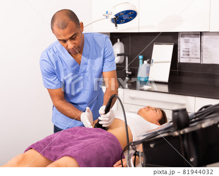 Beautician performing rf lifting procedure for female patient Beautician performing rf lifting procedure for female patient 81944032