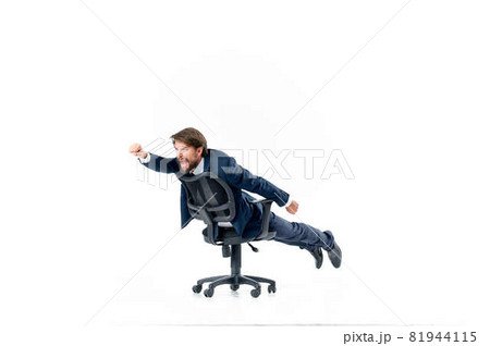 Cheerful business man in a suit is rolling in an office manager chair Cheerful business man in a suit is rolling in an office manager chair 81944115