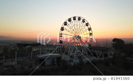 Ferris wheel on the green hill Kok Tobe at sunset 81945360