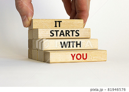 It starts with you symbol. Wooden blocks with words 'it starts with you' on beautiful white background. Businessman hand. Business, motivational and it starts with you concept. Copy space. It starts with you symbol. Wooden blocks with words 'it starts with you' on beautiful white background. Businessman hand. Business, motivational and it starts with you concept. Copy space. 81946576