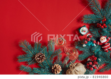 Fir branch and gift box on red background 81946860