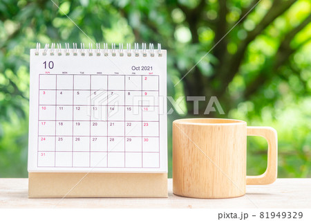 October month, Calendar desk 2021 for organizer to planning and reminder on wooden table with green nature background. 81949329
