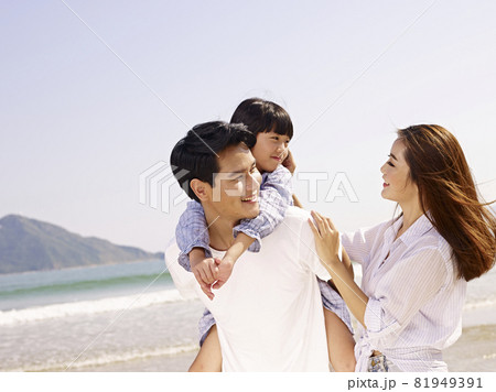 happy asian family having fun on beach 81949391