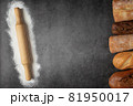 Baking dark background with copy space with various fresh baked bread and rolling pin with ingredient flour top view. 81950017