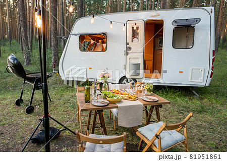 Served table with chairs around standing against house on wheels 81951861