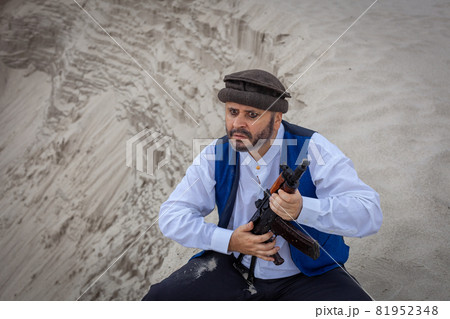 A Taliban soldier monitors a road in Afghanistan. 81952348