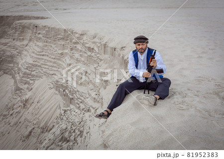 A Taliban soldier monitors a road in Afghanistan. 81952383