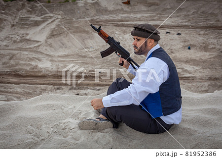 A Taliban soldier monitors a road in Afghanistan. A Taliban soldier monitors a road in Afghanistan. 81952386