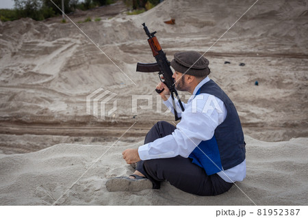 A Taliban soldier monitors a road in Afghanistan. 81952387