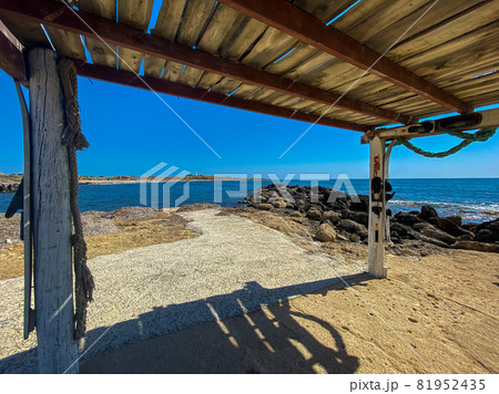 Waves of the Mediterranean Sea on a rocky coast in Cyprus near the city of Paphos in sunny summer weather. Crystal clear emerald water and rocky coastline of the Mediterranean Sea, Cyprus 81952435