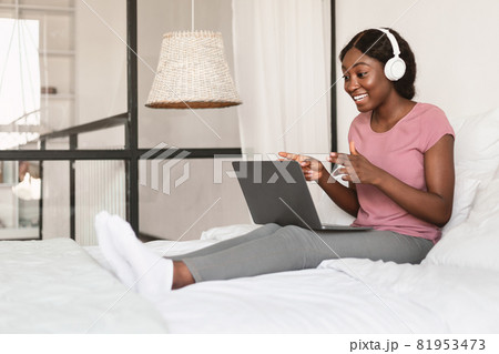 African American Lady Making Video Call Using Laptop At Home African American Lady Making Video Call Using Laptop At Home 81953473