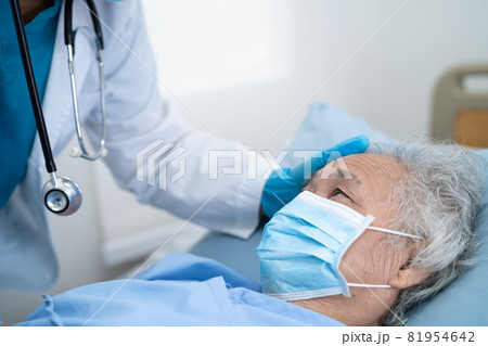 Doctor help Asian senior or elderly old lady woman patient wearing a face mask in hospital for protect safety infection and kill Covid-19 Coronavirus. Doctor help Asian senior or elderly old lady woman patient wearing a face mask in hospital for protect safety infection and kill Covid-19 Coronavirus. 81954642