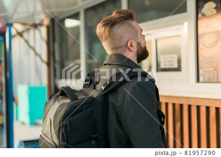 Portrait of man choosing fast food in food truck in the street. Meal, food industry and streetfood concept. Portrait of man choosing fast food in food truck in the street. Meal, food industry and streetfood concept. 81957290
