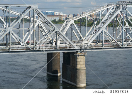 Arch of a railway bridge over a river in an industrial city. Arch of a railway bridge over a river in an industrial city. 81957313