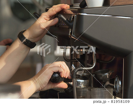 Coffee preparation at a traditional farmers market. A barista prepares fresh espresso at an outdoor market in Prague, Zizkov district. Coffee preparation at a traditional farmers market. A barista prepares fresh espresso at an outdoor market in Prague, Zizkov district. 81958109