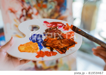 close up of female painters hand holding a paint brush close up of female painters hand holding a paint brush 81959467