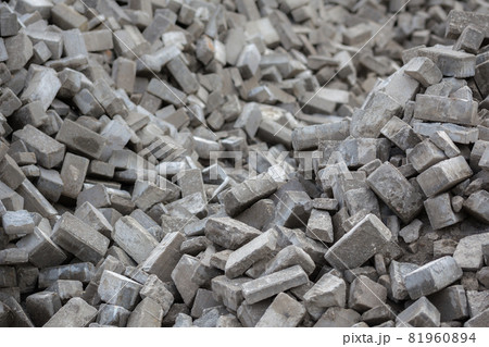 Pile of disassembled gray pavement bricks with selective focus 81960894