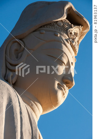 Face closeup of Ryozen Kannon Bodhisattva Avalokiteshvara statue, illuminated by an amazing sunlight. Face closeup of Ryozen Kannon Bodhisattva Avalokiteshvara statue, illuminated by an amazing sunlight. 81963137
