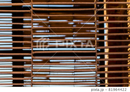 Rusted welded iron fence closeup 81964422