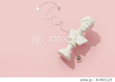 Creative composition with pendant on pink background. Trendy jewelry in minimalist style 81965124