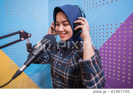 muslim woman girl is recording a podcast in her studio 81967700