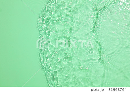 Empty Glass podium on transparent clear green water texture with splashes and waves in sunlight. Abstract nature background for product presentation 81968764