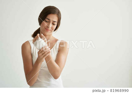 woman with an injured arm tied with a bandage health problems woman with an injured arm tied with a bandage health problems 81968990