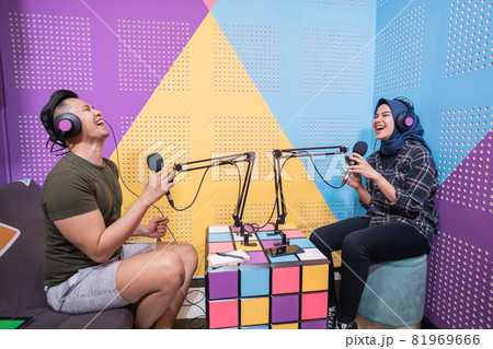 muslim asian woman and man talking on podcast studio together 81969666