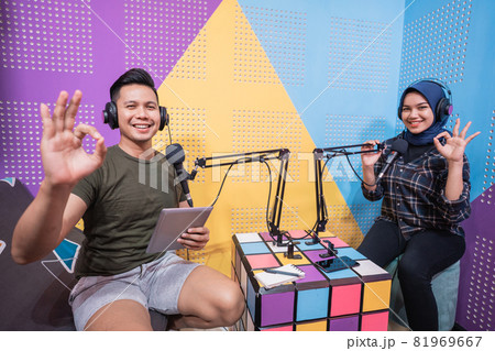 man and woman podcast in studio and showing thumb up 81969667