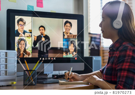 Closeup Asian woman hand writing lecture when online learning via video conference with teacher or speaker with colleague when Covid-19 pandemic, Coronavirus outbreak,online meeting,new normal concept 81970273