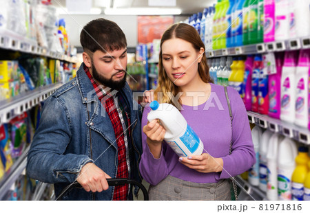 couple chooses household chemicals in supermarket couple chooses household chemicals in supermarket 81971816