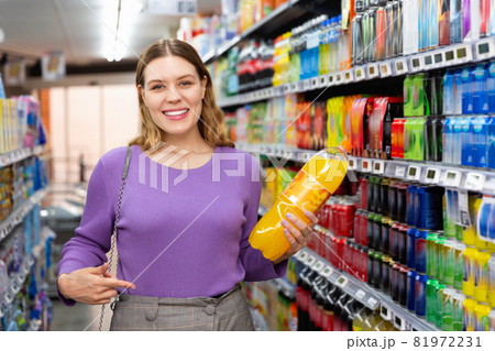 Portrait of young happy woman satisfied with choosed carbonated soft drinks in food store 81972231