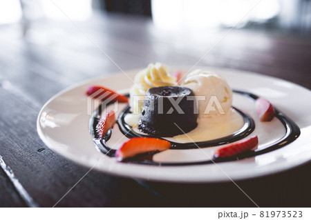 hot chocolate lava cake with vanilla ice cream and fresh strawberry hot chocolate lava cake with vanilla ice cream and fresh strawberry 81973523