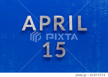 the words april 15 layed on blue painted board with thick silver metal aphabet characters the words april 15 layed on blue painted board with thick silver metal aphabet characters 81975553