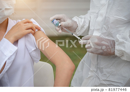 Doctor protective suit taking a nasal swab from a person to test for possible coronavirus infection. Doctor protective suit taking a nasal swab from a person to test for possible coronavirus infection. 81977446