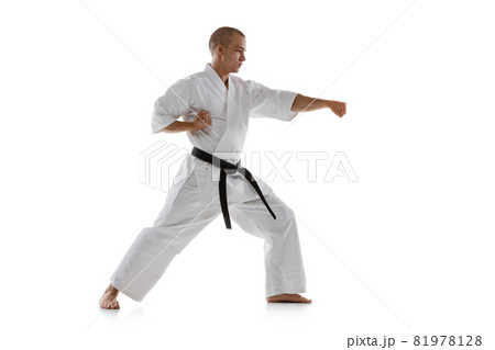 Full-length portrait of caucasian sportsman standing in punch pose isolated over white background. Karate, judo, taekwondo sport Full-length portrait of caucasian sportsman standing in punch pose isolated over white background. Karate, judo, taekwondo sport 81978128