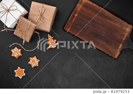 Christmas composition. Xmas cookies, gifts, festive decoration on black background. Flat lay, top view, with copy space. 81979253