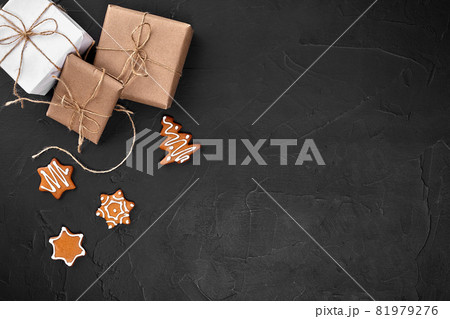 Christmas composition. Xmas cookies, gifts, festive decoration on black background. Flat lay, top view, with copy space. 81979276