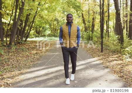 African american student walking in the park in autumn season 81980196