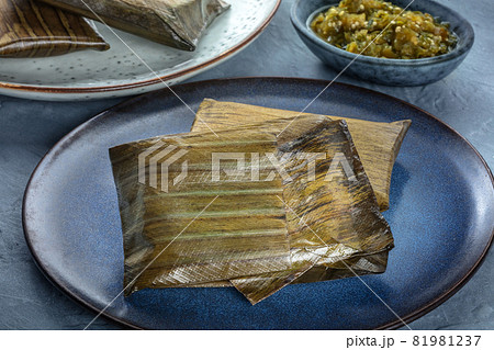 Tamales, traditional dish of Mexican cuisine, wrapped in green leaves 81981237