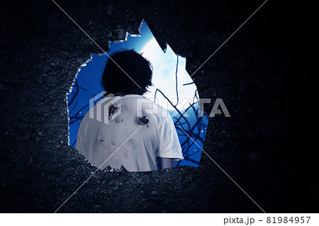 Wall hole with a scary zombie standing 81984957