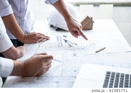 Team of engineering or architect meeting and discussing on blueprint and building model while checking information on sketching for architectural project 81985751