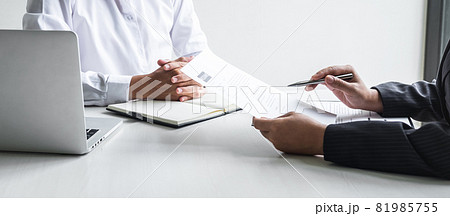 Employer or committee holding reading a resume with talking during about his profile of candidate, employer in suit is conducting a job interview, manager resource employment and recruitment concept 81985755