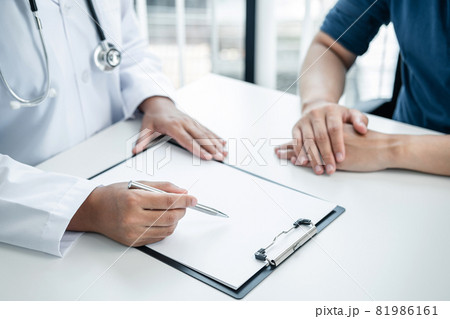 Doctor is explaining the symptoms to the patient at medical clinic Doctor is explaining the symptoms to the patient at medical clinic 81986161