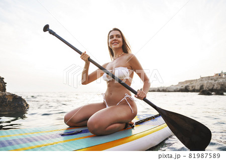 Beautiful model paddlbording relaxing in the sea with clean water 81987589
