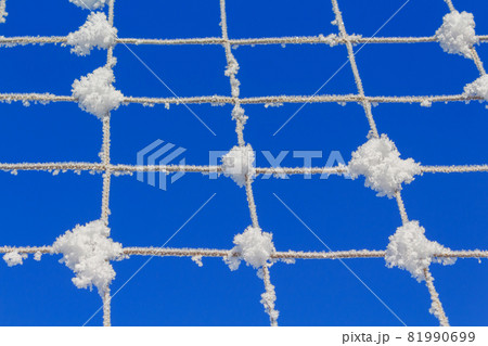 Volleyball net covered with snow. Nature's minimalism. Volleyball net covered with snow. Nature's minimalism. 81990699